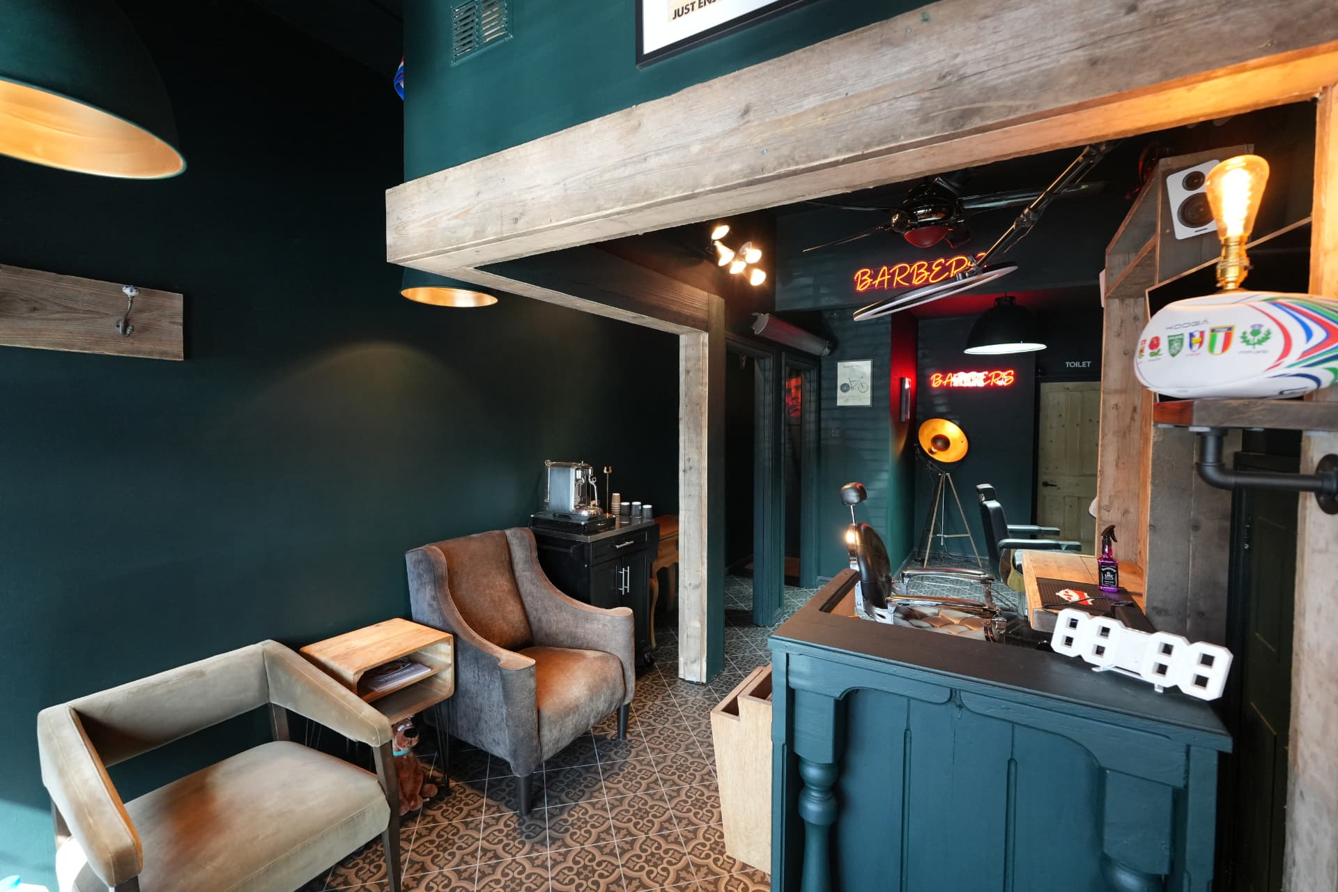 Waiting area with leather armchairs, coffee machine and patterned tiled floor