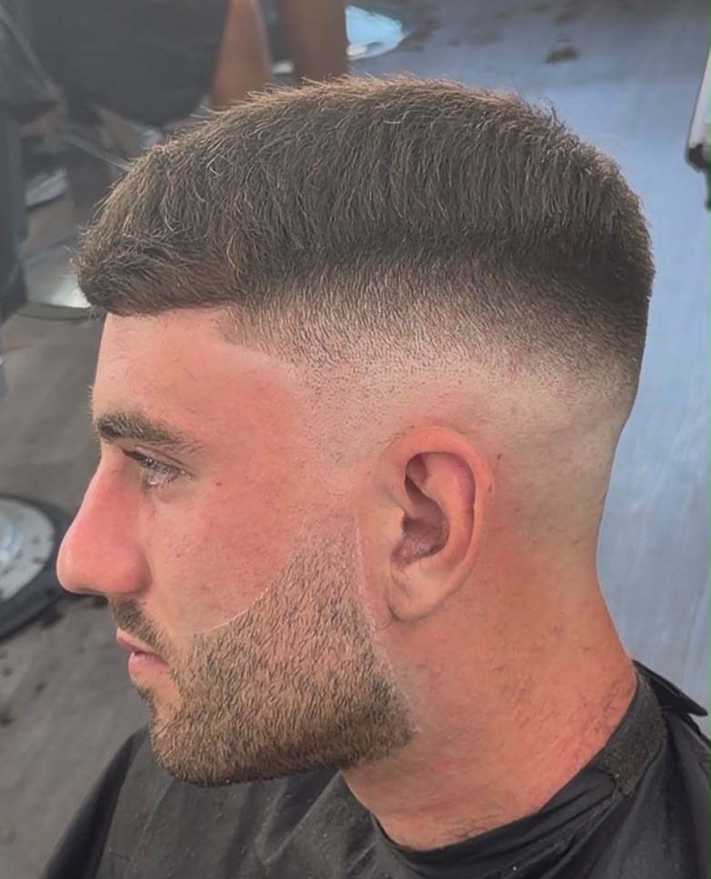 Skin fade with sharp line-up and beard blend